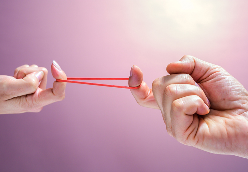 Two hands stretching out a rubber band