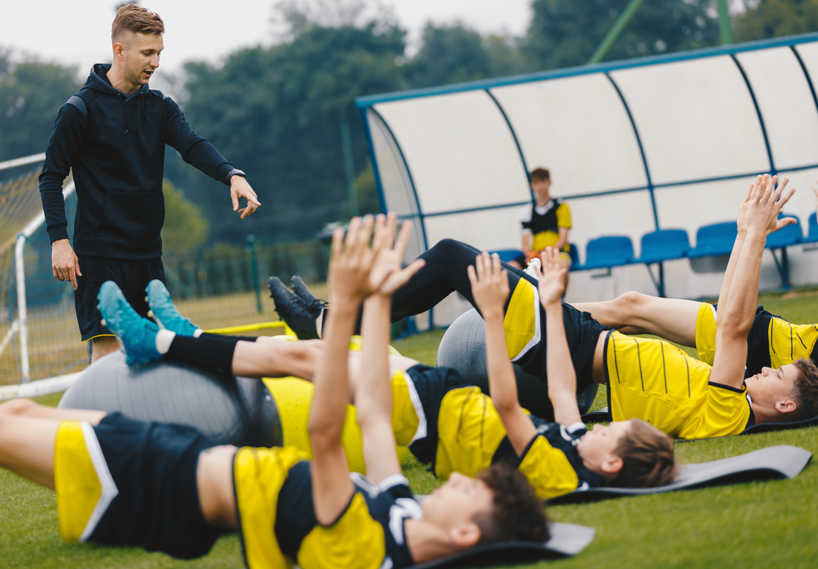 Sports team with coach doing training