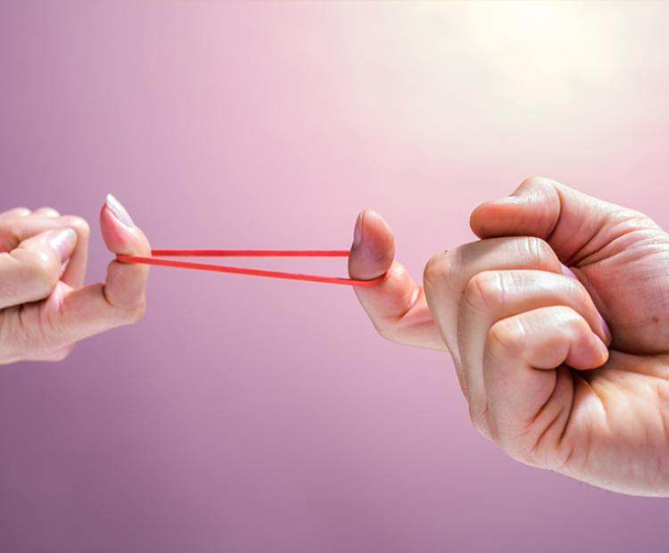 Two hands stretching out a rubber band