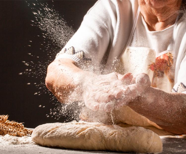 woman in apron baking bread